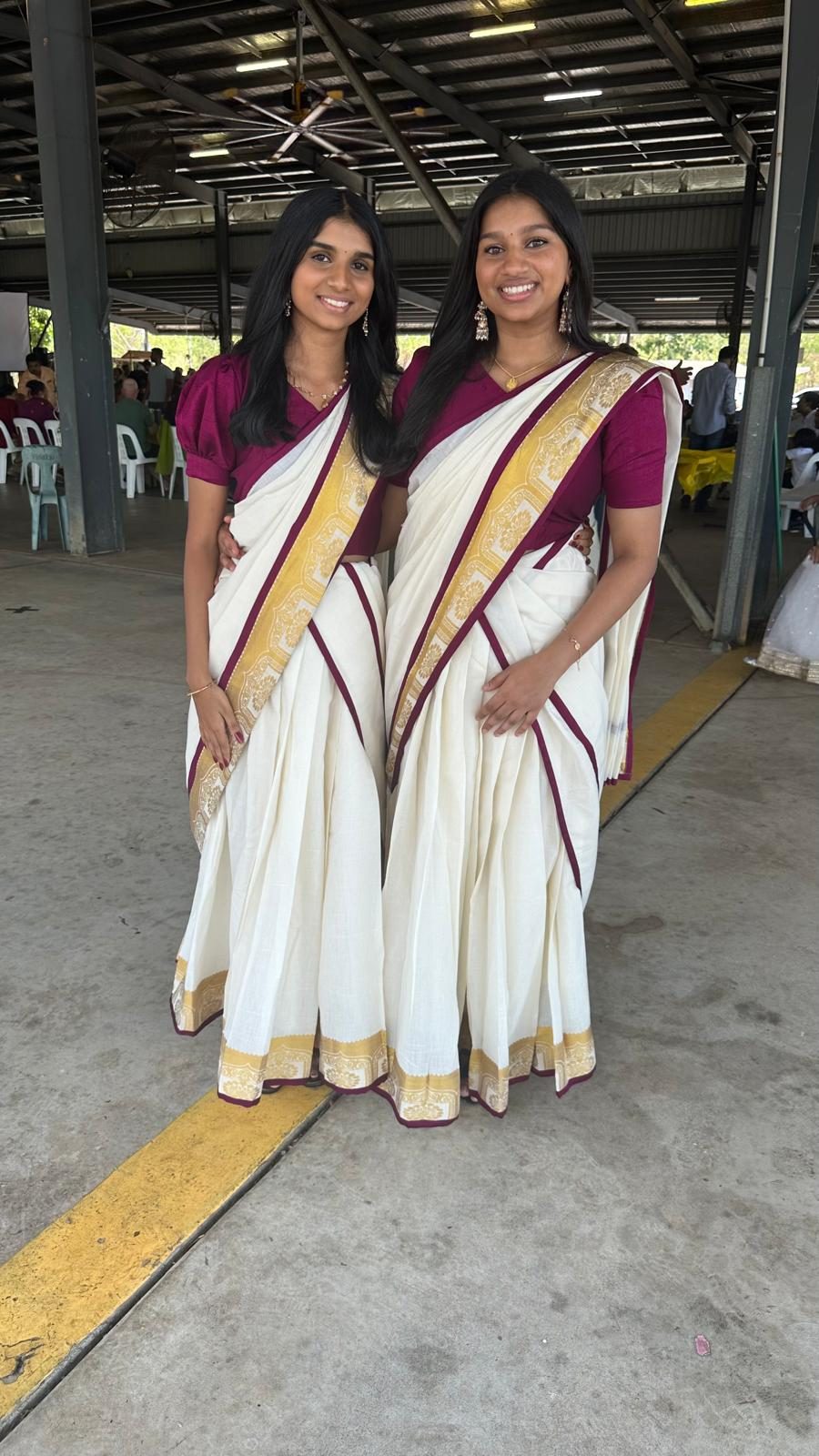 Two customers in matching Kerala kasavu sarees