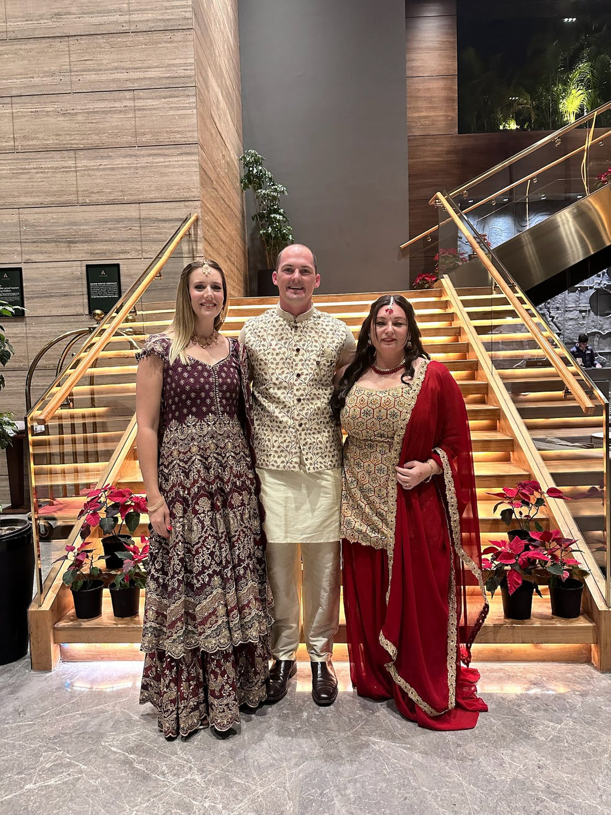 Group in lehengas and a sherwani at a wedding